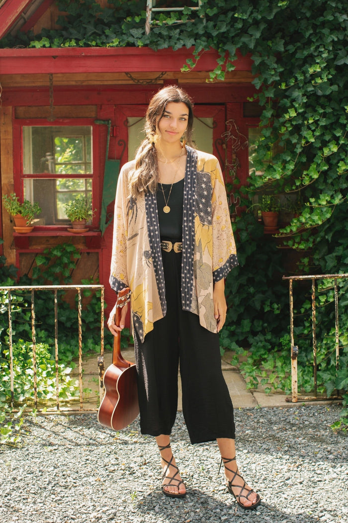 Model wearing our matinee length kimono featuring vintage-inspired Milk & Honey print with 1904 typography and floral woodcuts – Market of Stars
