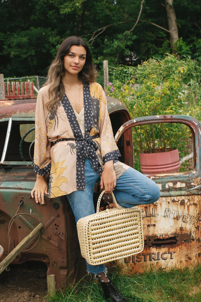 Model wearing our matinee length kimono featuring vintage-inspired Milk & Honey print with 1904 typography and floral woodcuts – Market of Stars