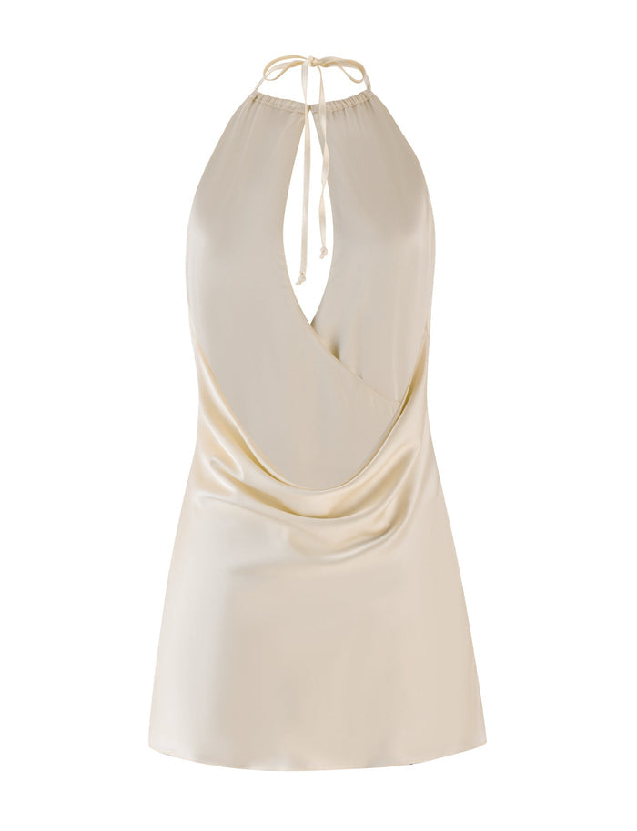 Introducing the MONROE MINI DRESS in cream from TIGERMIST, featuring a satin finish with a smooth and shiny texture. This piece boasts a wrap-style design with a tie closure at the neck and showcases a draped front for an elegant appeal.