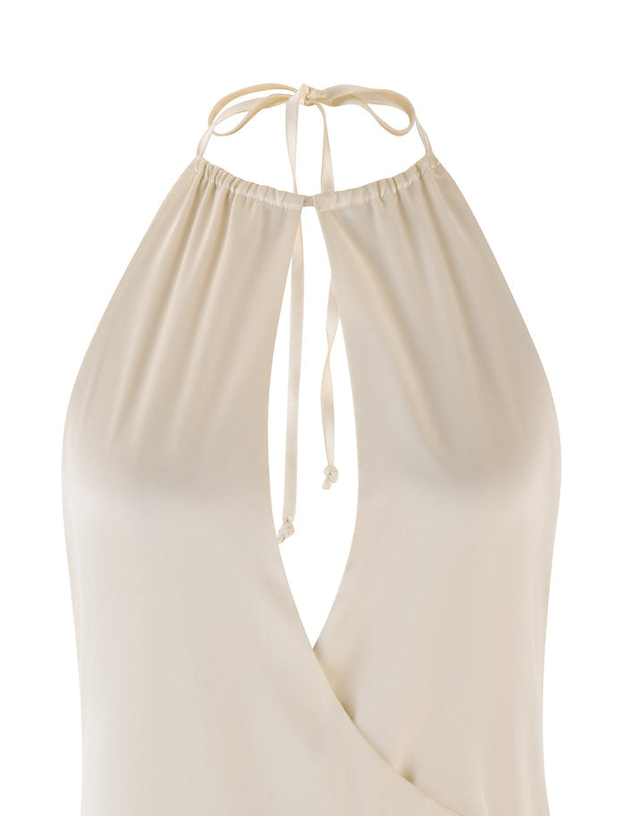 A halter neck top in cream featuring a deep V-neckline and thin straps that tie at the back, crafted from a soft fabric with a subtle sheen reminiscent of the elegant TIGERMIST MONROE MINI DRESS.