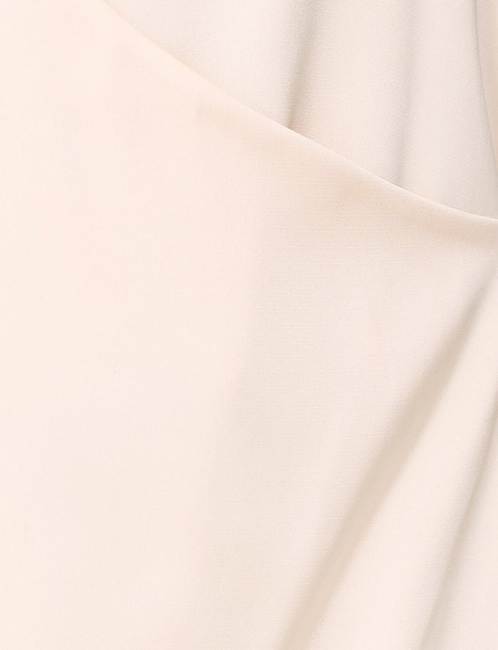 A close-up of the Monroe Mini Dress by TIGERMIST showcases the light beige fabric featuring soft folds and creases, highlighting its smooth texture in a cream colorway.