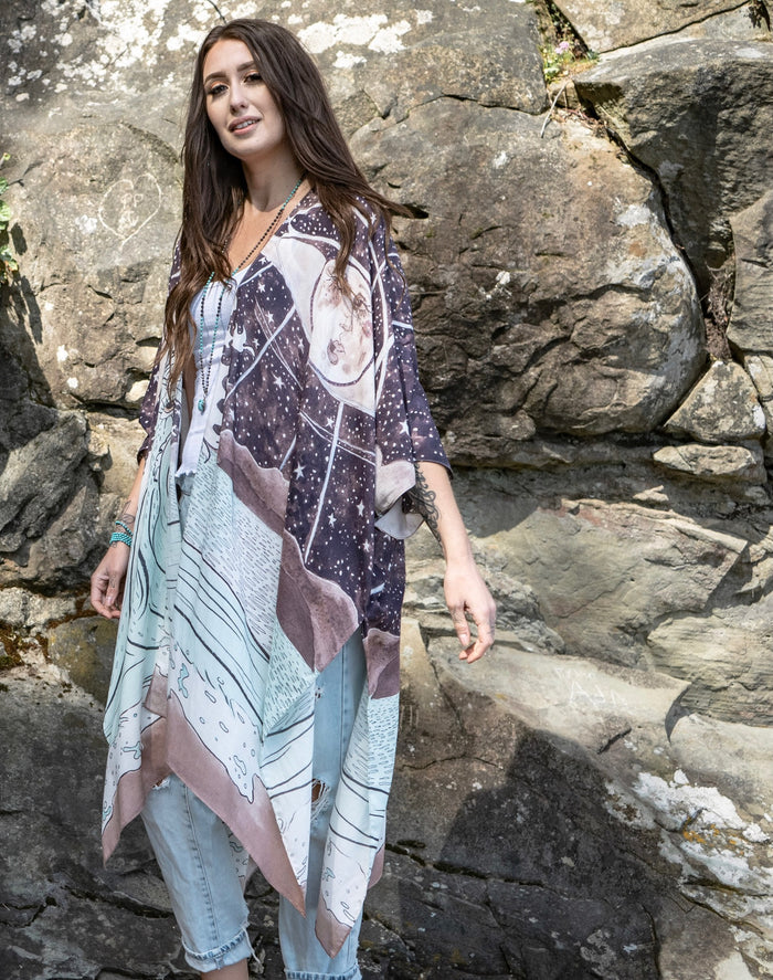 Model wearing Moonstruck Goddess Duster featuring original artwork by Leslie Love, inspired by the ocean, the night sky, and the artist’s handmade botanical inks – Market of Stars.