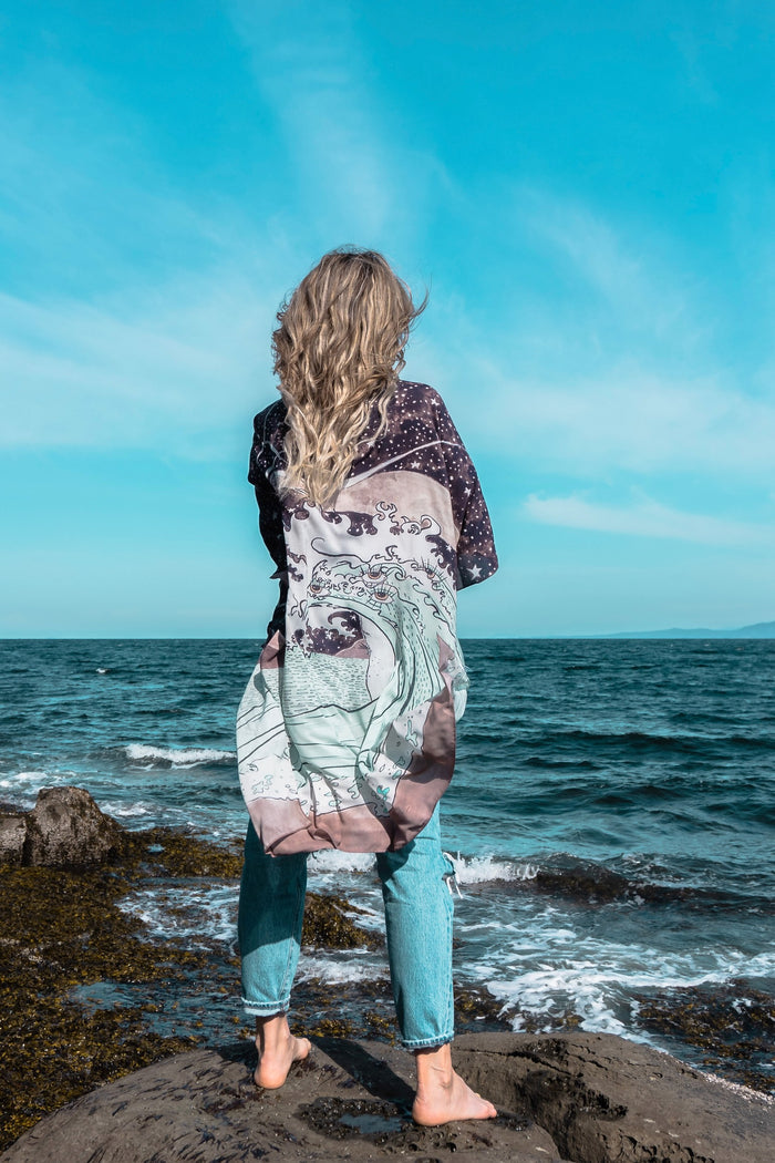 Model wearing Moonstruck Goddess Duster featuring original artwork by Leslie Love, inspired by the ocean, the night sky, and the artist’s handmade botanical inks – Market of Stars.
