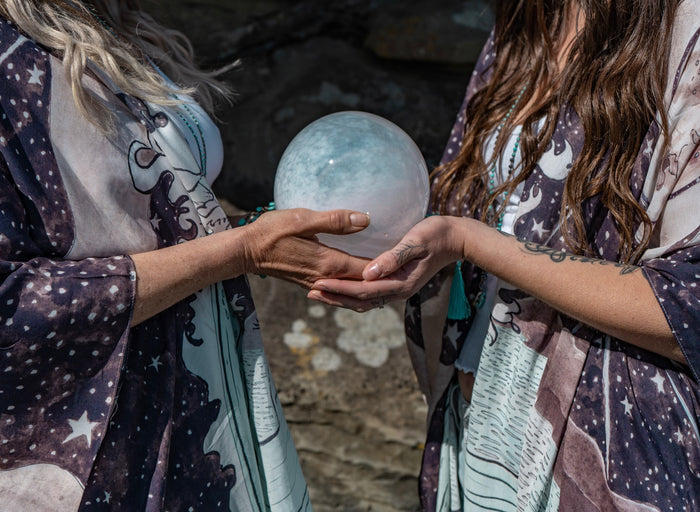 Model wearing Moonstruck Goddess Duster featuring original artwork by Leslie Love, inspired by the ocean, the night sky, and the artist’s handmade botanical inks – Market of Stars.