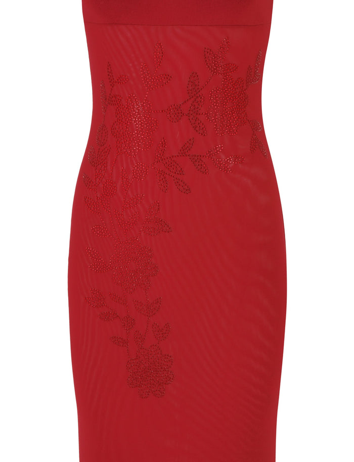 A close-up of the TIGERMIST Octavia Maxi Dress - Red in Cherry Red reveals a maxi-length design, featuring intricate floral lace detailing across the midsection, creating an elegant and stylish pattern.