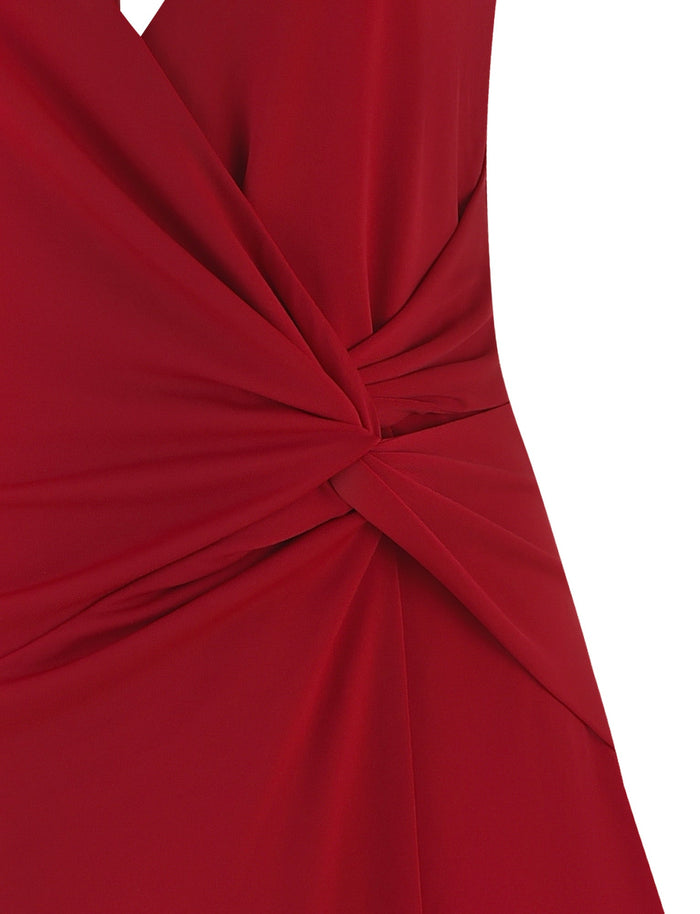 Close-up of the TIGERMIST PARRIS DRESS in red, featuring smooth, slightly shiny fabric with draped gathering and a twisted knot detail at the waist.