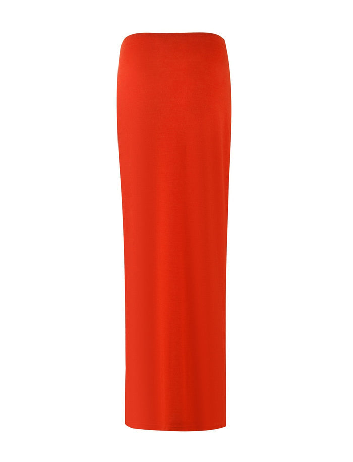 Introducing the PAXTON SKIRT - RED : OMBRE from TIGERMIST: a striking red, ankle-length pencil skirt that boasts a sleek and fitted design. The high split adds a touch of allure, while the smooth and stretchy fabric ensures a form-fitting silhouette. This elegant skirt features no visible patterns or embellishments.
