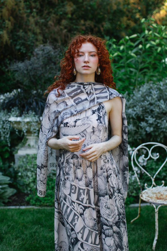 Model wearing Peace, Wine & Sunshine Bohéme Slip Dress featuring botanical collages and playful peace, wine and sunshine lettering on the hem – Market of Stars.