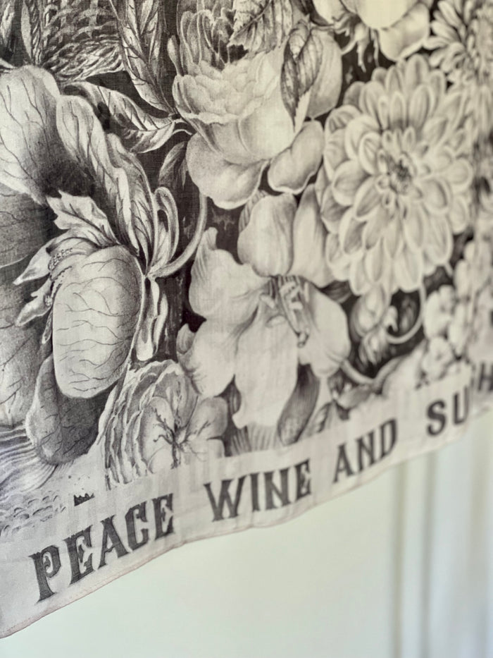 Model wearing Peace, Wine & Sunshine Bohéme Slip Dress featuring botanical collages and playful peace, wine and sunshine lettering on the hem – Market of Stars.