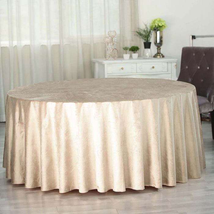 Round gold tablecloth draping a table in an elegant setting.