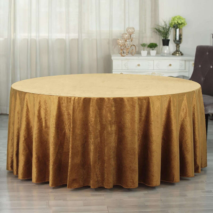 Round gold tablecloth draping beautifully over a circular table.