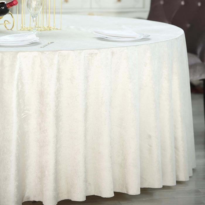 Round cream tablecloth with elegant draping and soft texture.