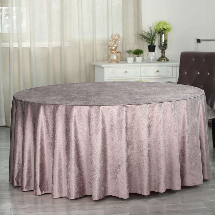 Round velvet tablecloth in soft mauve color, elegantly draped on a table.