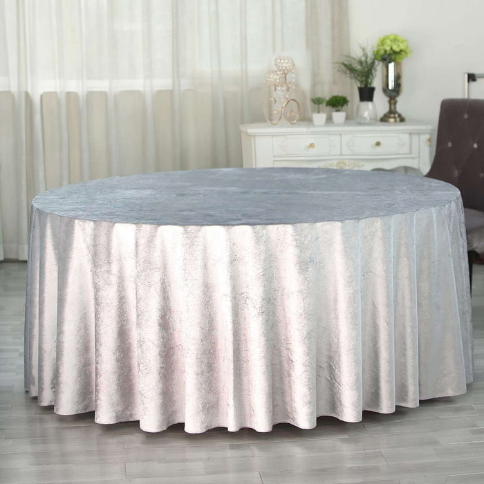 Round silver tablecloth draped elegantly over a table in a stylish setting.