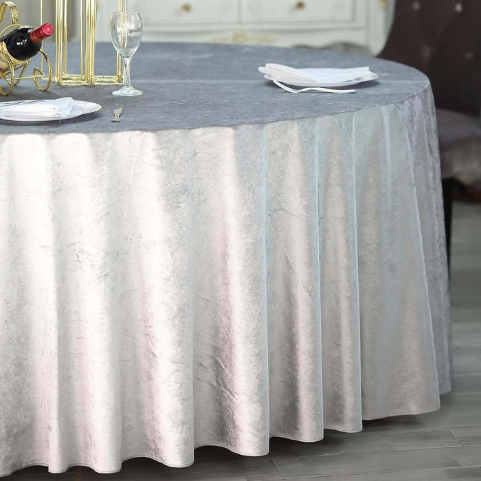 Elegant gray tablecloth draping a round table in a stylish dining setting.