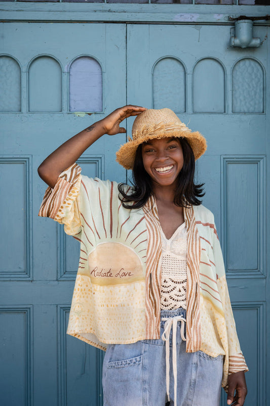 Model wearing Peace, Wine & Sunshine Bohéme Slip Dress featuring botanical collages and playful peace, wine and sunshine lettering on the hem – Market of Stars.