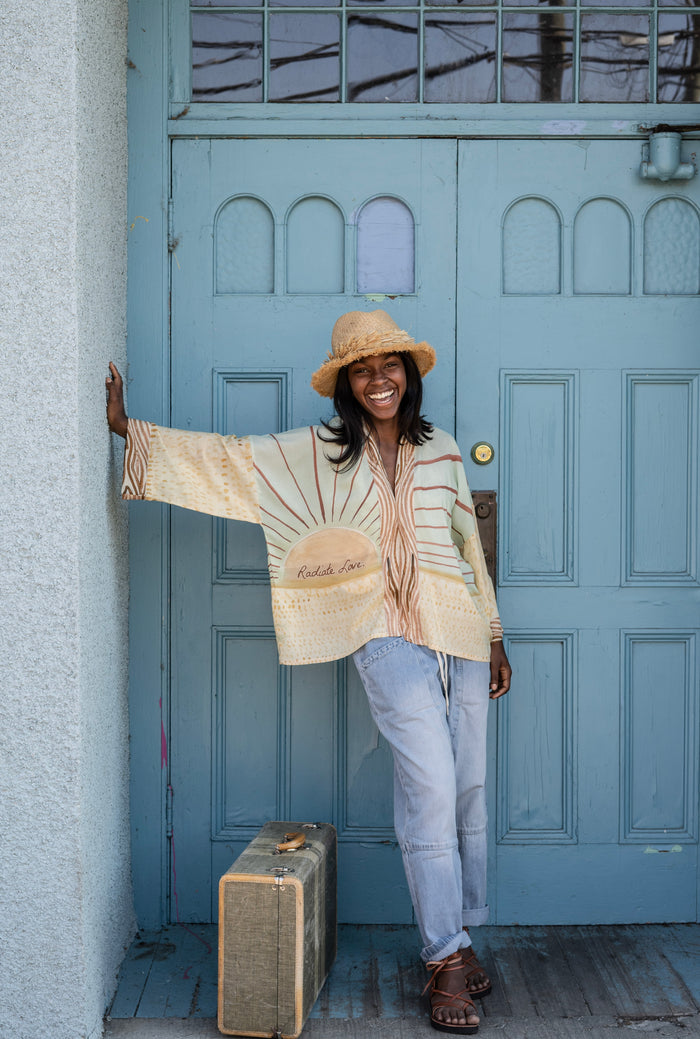 Model wearing Peace, Wine & Sunshine Bohéme Slip Dress featuring botanical collages and playful peace, wine and sunshine lettering on the hem – Market of Stars.
