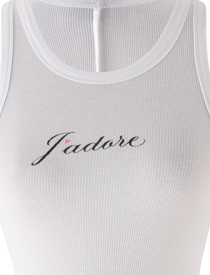 A close-up of the RAFAELLA TANK - WHITE by TIGERMIST, shown on a mannequin, features ribbed white fabric and "J'adore" in black cursive across the chest.