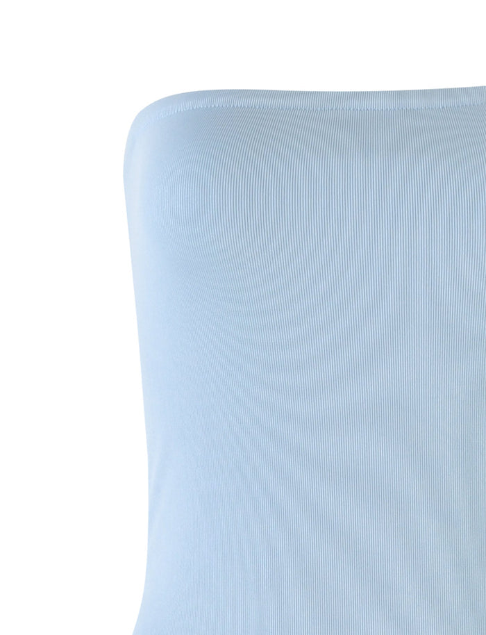 Close-up of a light blue TIGERMIST ROMINA DRESS. The material appears to be stretchy and form-fitting, with a subtle, textured pattern. The background is plain white, highlighting the texture and color of the dress.