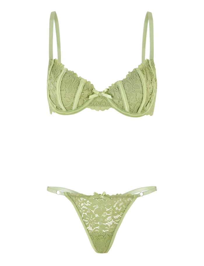 The ROSALYN SET - GREEN by TIGERMIST is a light green lace lingerie ensemble that includes a coordinating bra and g-string with adjustable straps. The bra provides underwire support and showcases delicate floral lace patterns. Designed for comfort, the high-stretch fabric complements the g-string's low-rise fit, adorned with matching lace details and thin side straps.