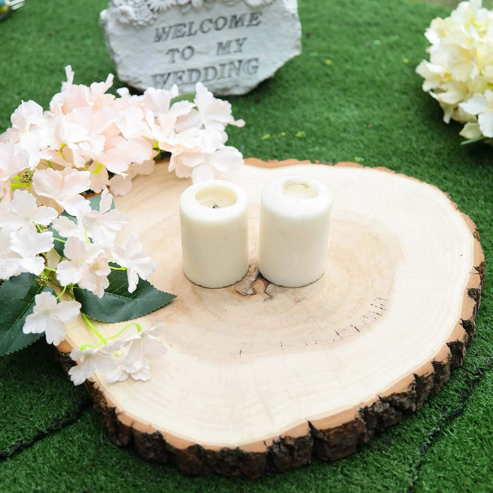 Candles on a wooden slice with flowers for a wedding decoration.