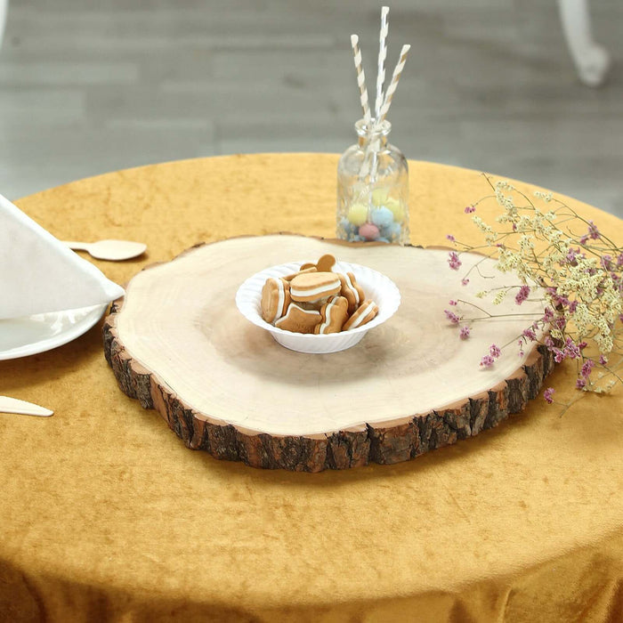 Wooden serving platter with cookies on a table set with a golden tablecloth.