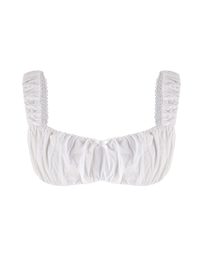 The SABRA TOP - WHITE by TIGERMIST is a white cotton cropped top featuring ruched fabric, wide gathered shoulder straps, and a structured bust, shown on a plain white background.