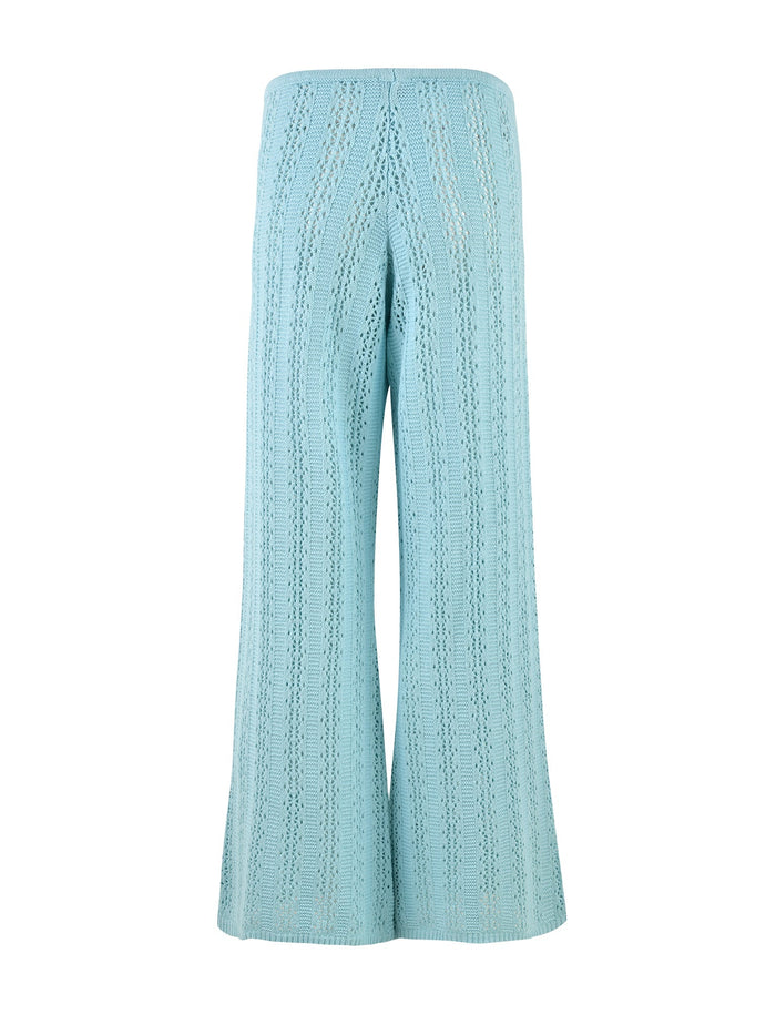 A pair of baby blue, high-waisted, wide-leg crochet pants from TIGERMIST called the SANDOR PANT - BLUE, featuring an intricate vertical pattern. The pants are displayed from the back, showcasing the detailed design and texture of the fabric.