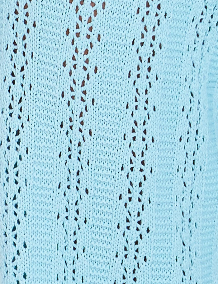 Light blue knitted fabric with a lace pattern featuring delicate, repeating floral designs and small holes. The texture appears soft and cozy, perfect for garments or accessories from TIGERMIST’s SANDOR PANT - BABY BLUE collection.