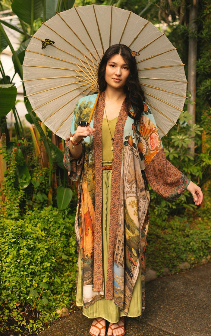 Model wearing Peace, Wine & Sunshine Bohéme Slip Dress featuring botanical collages and playful peace, wine and sunshine lettering on the hem – Market of Stars.