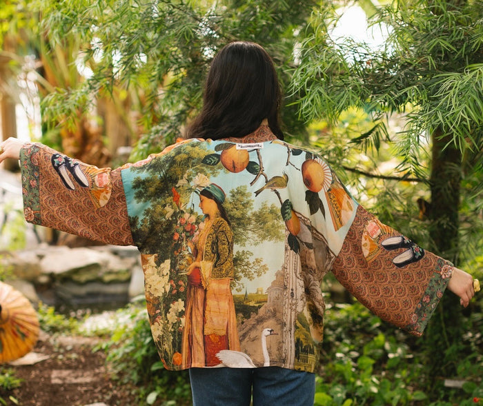 Model wearing Peace, Wine & Sunshine Bohéme Slip Dress featuring botanical collages and playful peace, wine and sunshine lettering on the hem – Market of Stars.