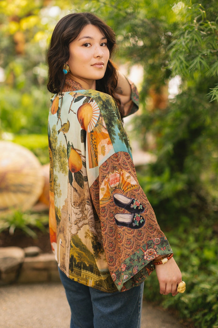 Model wearing Peace, Wine & Sunshine Bohéme Slip Dress featuring botanical collages and playful peace, wine and sunshine lettering on the hem – Market of Stars.