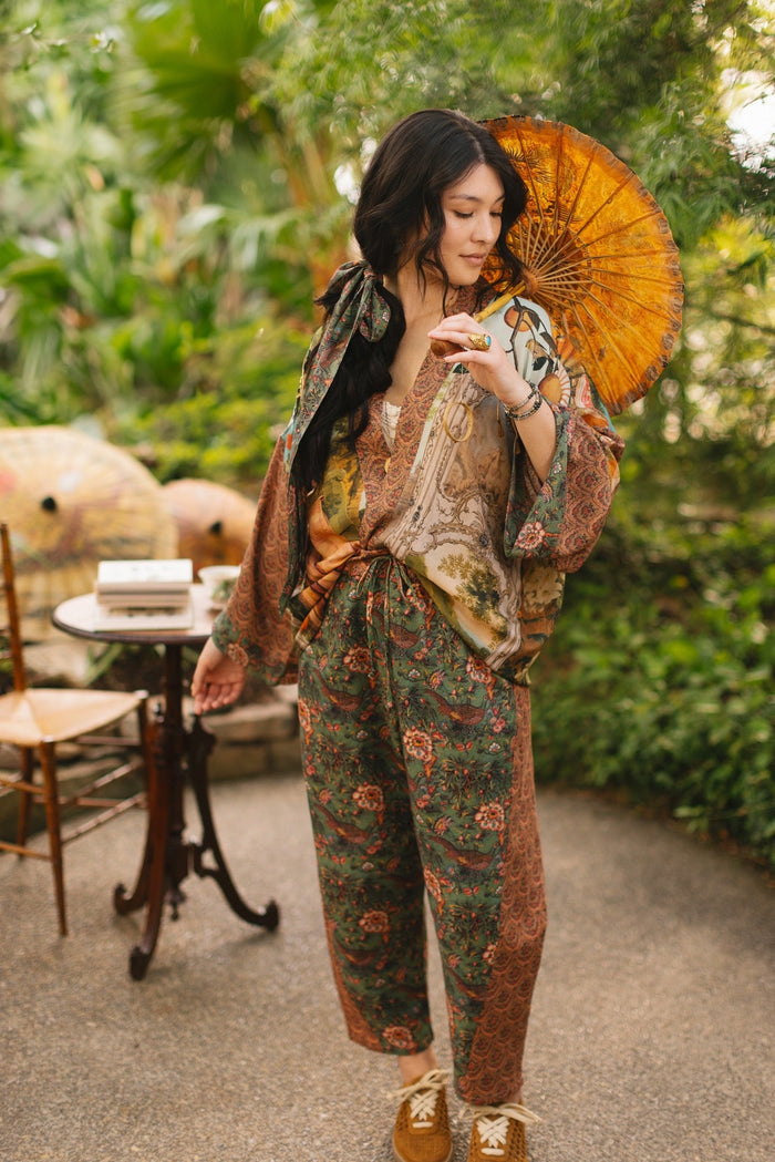 Model wearing Peace, Wine & Sunshine Bohéme Slip Dress featuring botanical collages and playful peace, wine and sunshine lettering on the hem – Market of Stars.