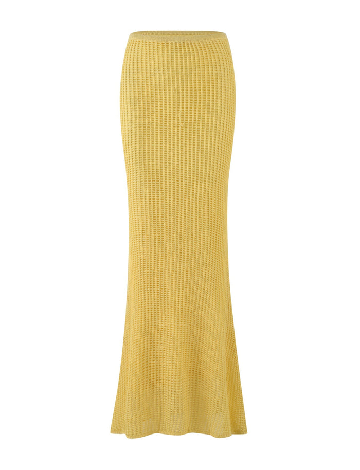 Introducing the SHAH SKIRT - YELLOW : LEMON by TIGERMIST, a stunning long yellow crochet skirt featuring a low-rise waist and a subtle flare towards the bottom. The material boasts an intricate textured, ribbed pattern throughout.