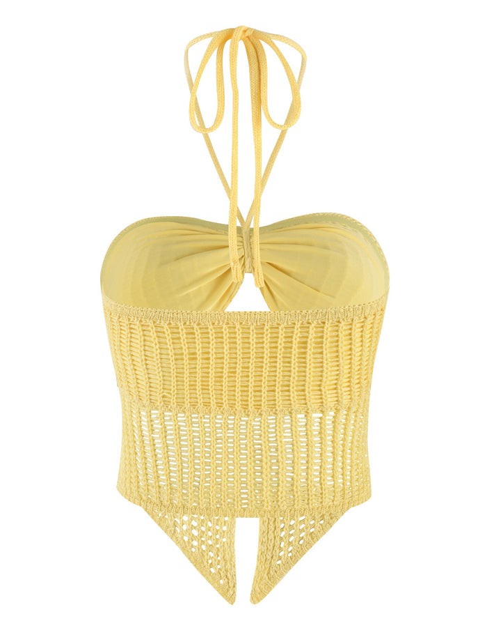 The SHAH TOP - YELLOW : LEMON from TIGERMIST is a yellow crochet halter top with a sweetheart neckline and a neck tie closure. This versatile multi-way top showcases an open-knit, transparent design at the bottom that extends into a pointed hem.