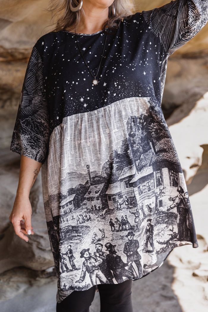 Model wearing a celestial knee-length artist dress in bamboo & wood blend viscose ft. the 1833 Leonid meteor shower in a dreamy star-filled night sky - Market of Stars.