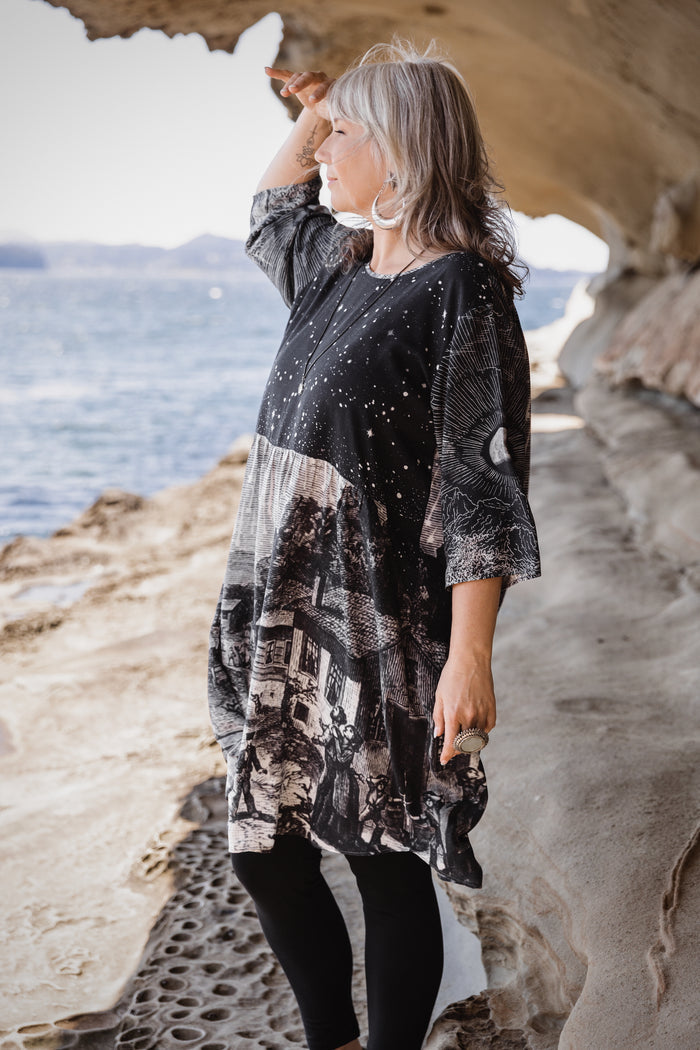 Model wearing a celestial knee-length artist dress in bamboo & wood blend viscose ft. the 1833 Leonid meteor shower in a dreamy star-filled night sky - Market of Stars.