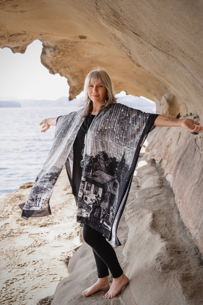 Model wearing a celestial flowy kimono duster in bamboo & wood blend viscose ft. the 1833 Leonid meteor shower in a dreamy star-filled night sky - Market of Stars.
