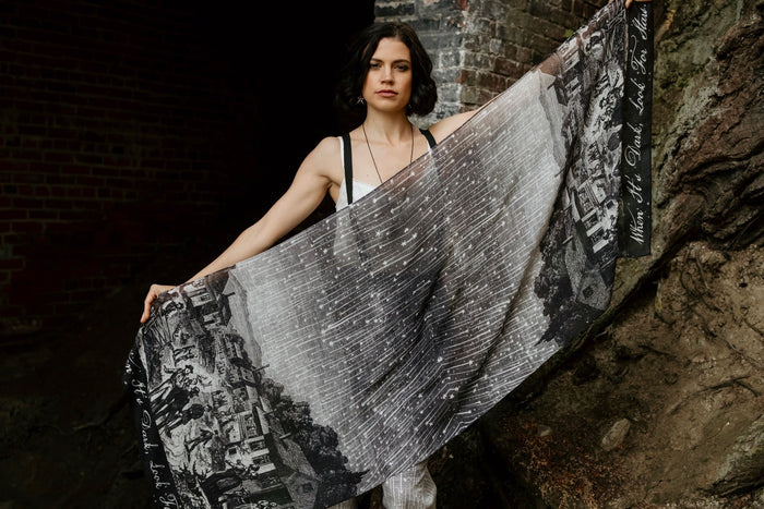 Model wearing the Stargazer Scarf featuring antique night sky illustrations and the quote "When it's dark, look for stars" – Market of Stars