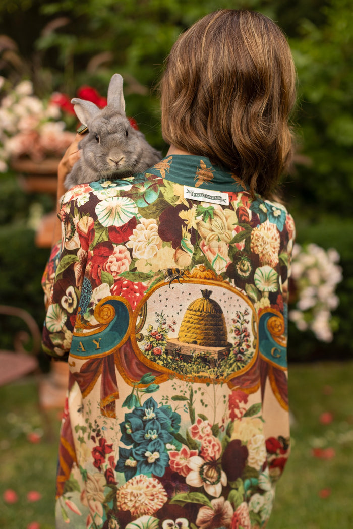 Model wearing Stay Gold Opera Duster with wildflower, bee, and bunny rabbit illustrations, golden script, and vintage collage in full-length kimono silhouette – Market of Stars