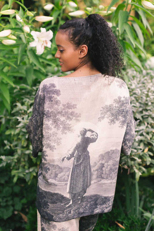 Model wearing the Still I Rise Luxe Tee with wide scoop neck and soft bamboo-based viscose, featuring vintage landscape etching and an inspiring message – Market of Stars