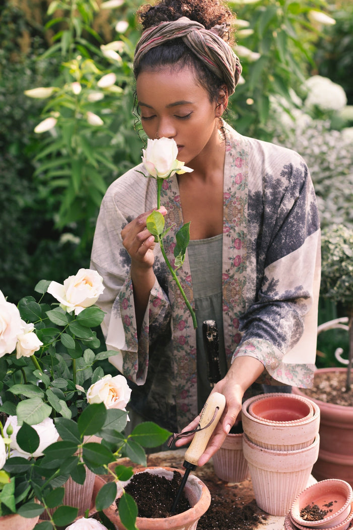 Model wearing our Still I Rise Pixie Duster with empowering message a bold, layered design featuring antique landscape etchings – Market of Stars
