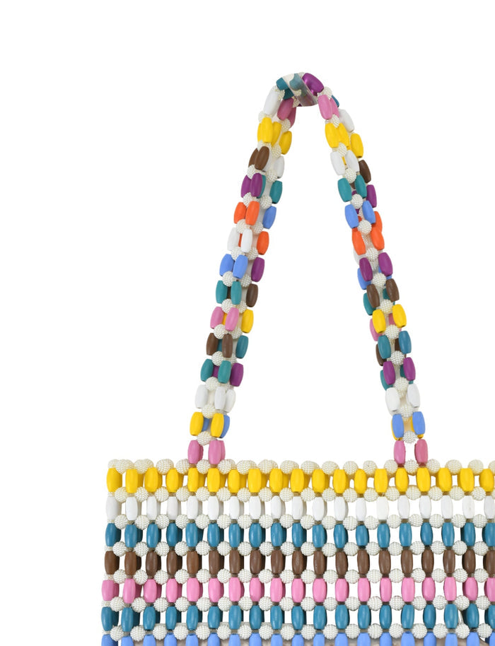 The STORMY BAG - STRIPE by TIGERMIST is a colorful beaded handbag with a geometric pattern in rainbow shades of white, pink, blue, yellow, orange, brown, and black. It features horizontal rows and a vibrant shoulder strap.