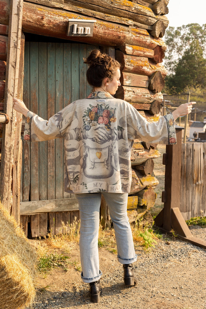 A cozy cardigan lined in fleece featuring Victorian collage artwork and the phrase “Life is nothing without friendship” – Market of Stars