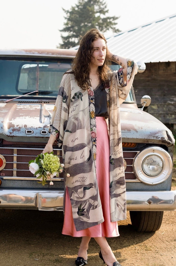 Clasped hands, radiant sun rays, and blooming florals in a joyful Victorian collage on our full-length Take My Hand Opera Duster