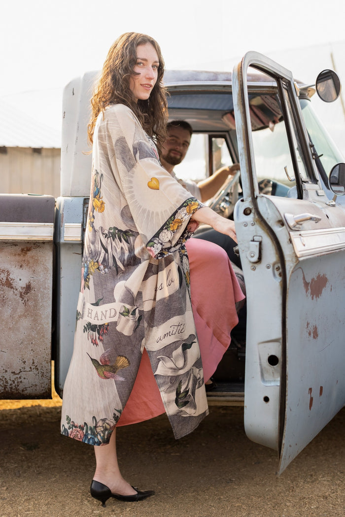 Clasped hands, radiant sun rays, and blooming florals in a joyful Victorian collage on our full-length Take My Hand Opera Duster