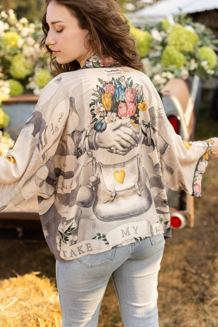 A joyful blend of 17th-century engravings, painted hearts, and hand-coloured florals on our cropped Take My Hand Pixie duster kimono – Market of Stars