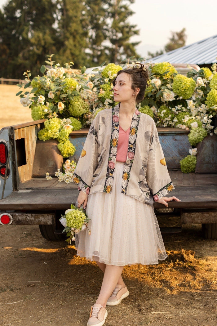A joyful blend of 17th-century engravings, painted hearts, and hand-coloured florals on our cropped Take My Hand Pixie duster kimono – Market of Stars