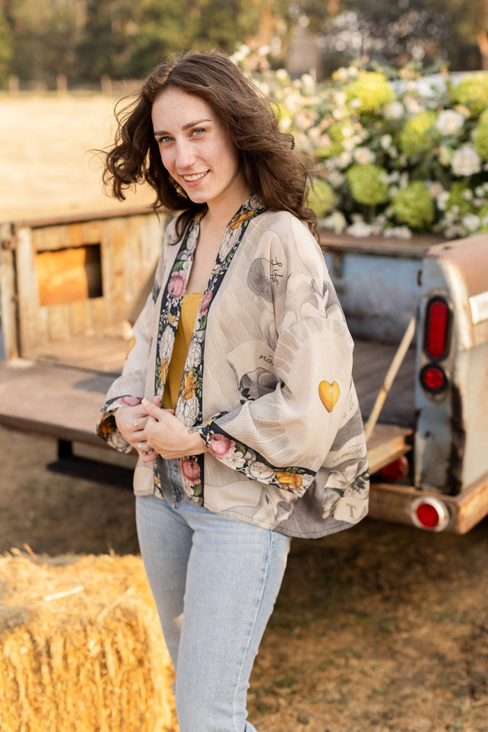 A joyful blend of 17th-century engravings, painted hearts, and hand-coloured florals on our cropped Take My Hand Pixie duster kimono – Market of Stars