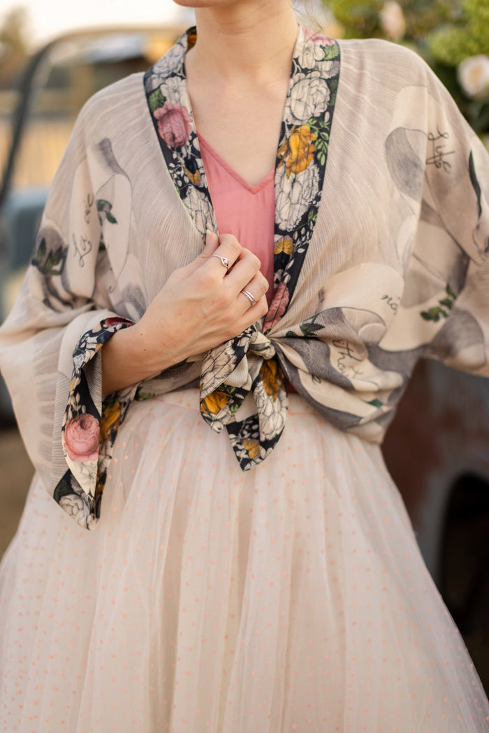 A joyful blend of 17th-century engravings, painted hearts, and hand-coloured florals on our cropped Take My Hand Pixie duster kimono – Market of Stars